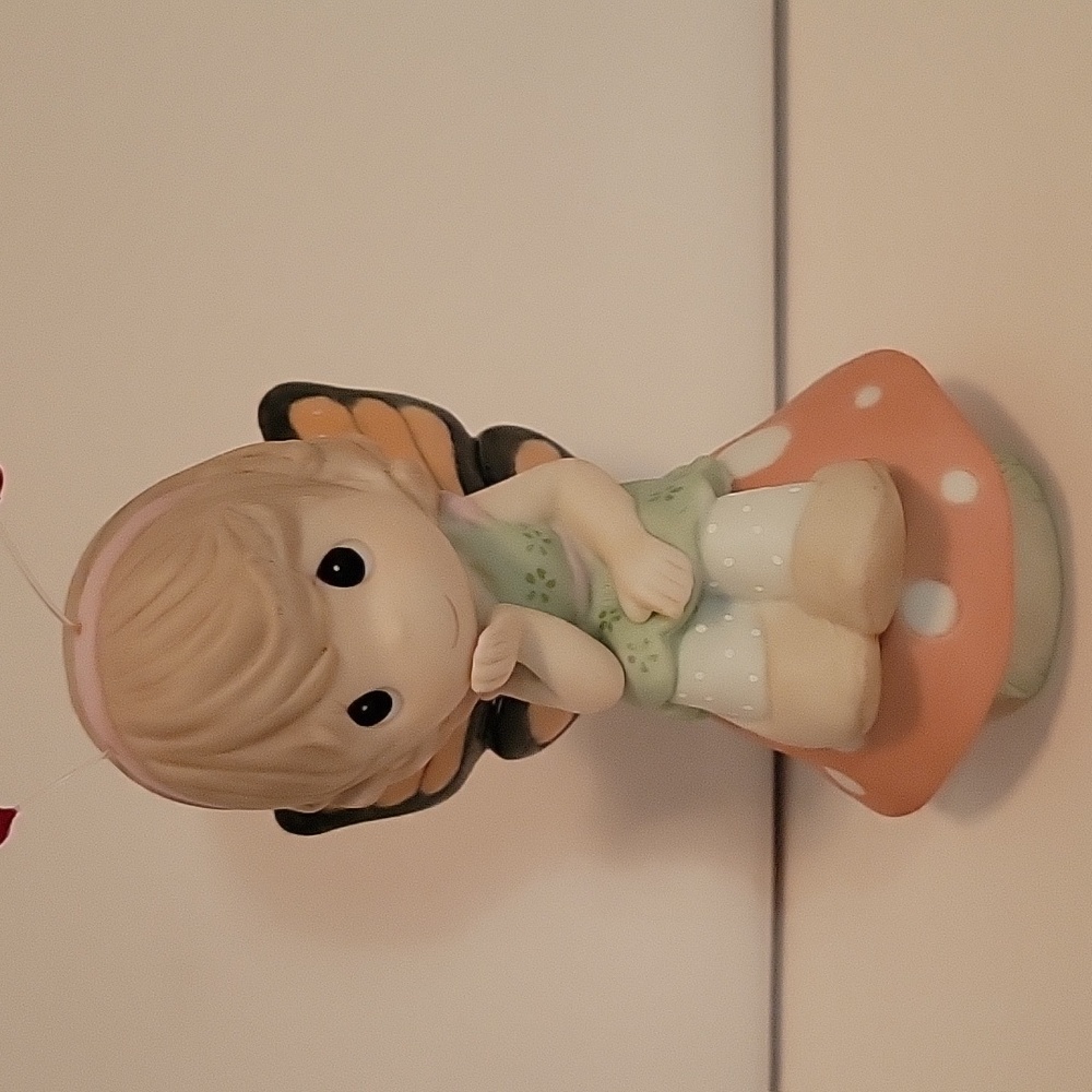 Precious Moments figurine, girl on polka-dot mushroom.